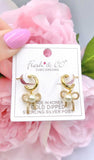 Gold huggie cuff earrings with bow pearl charm