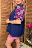 Navy blouse with pink floral embroidery sleeves