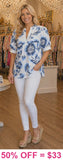 White v-neck top with blue floral print