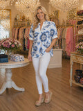 White v-neck top with blue floral print