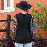 Black quilted top with geo print sleeves