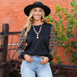 Black quilted top with geo print sleeves