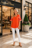 Orange top with chiffon sleeve