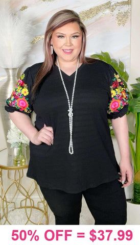 Black v-neck top with colorful embrodiery puff sleeves