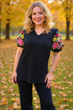 Black v-neck top with colorful embrodiery puff sleeves